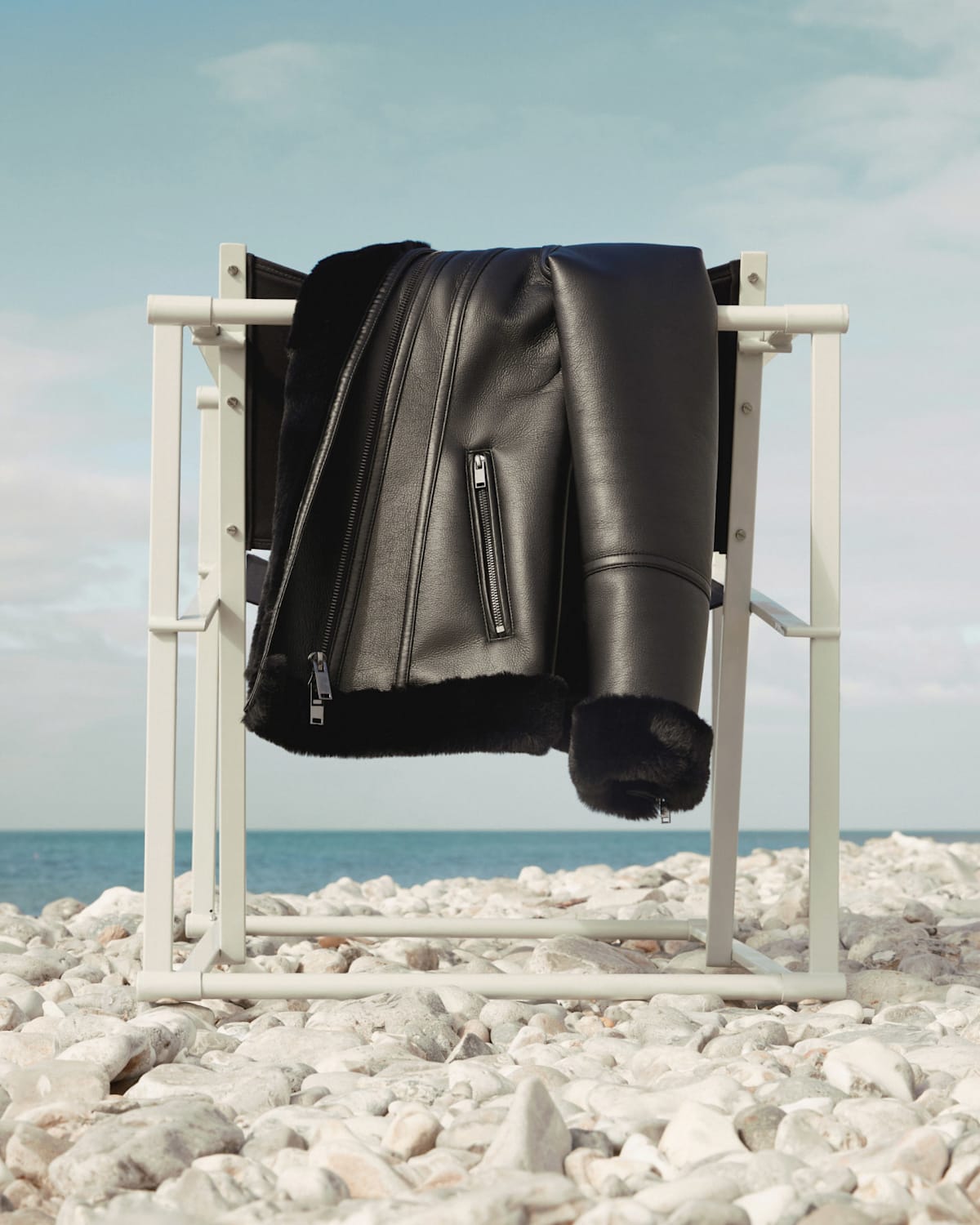 Image of leather coat draped over a chair.