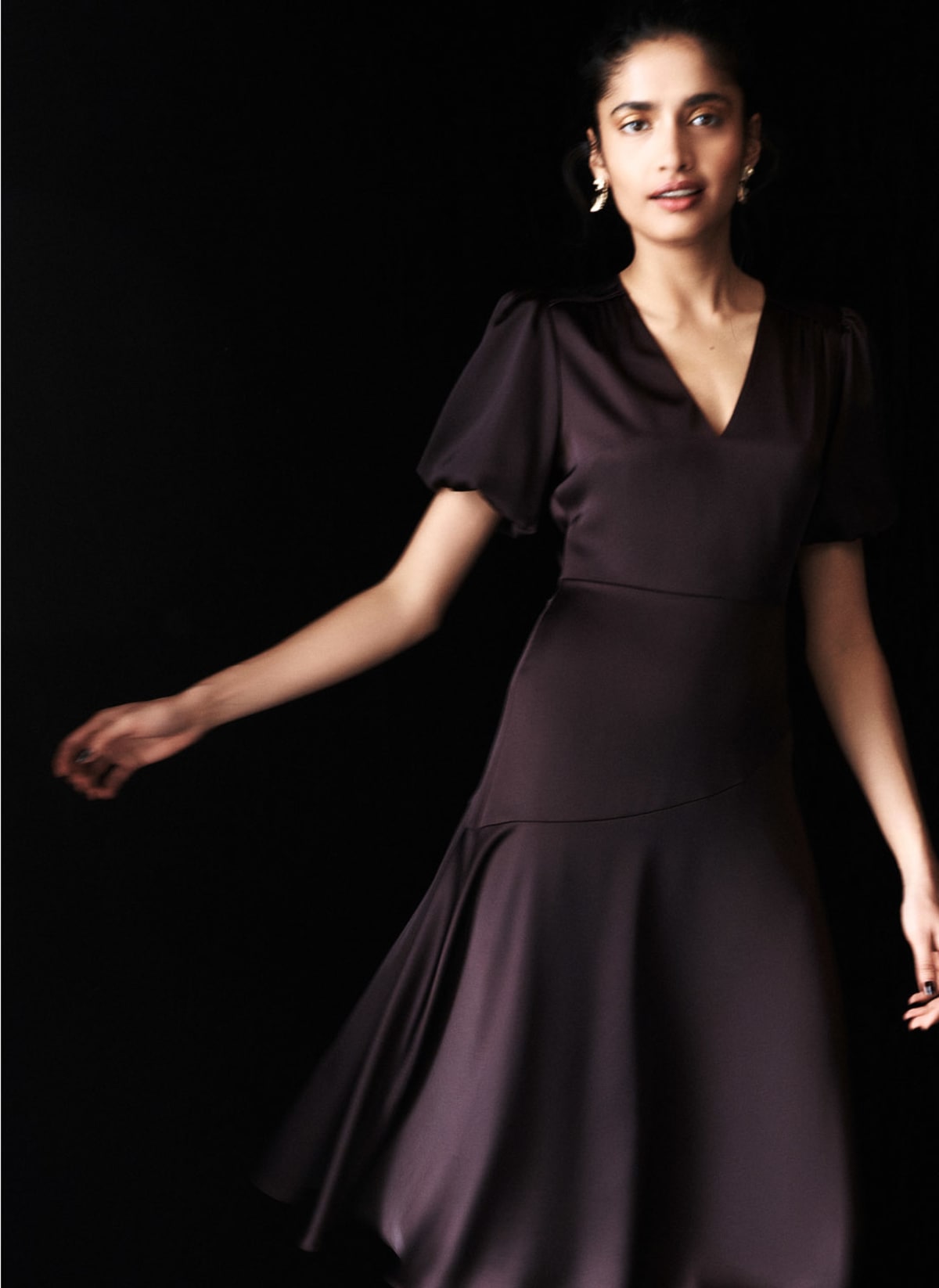Model photographed in brown dress.