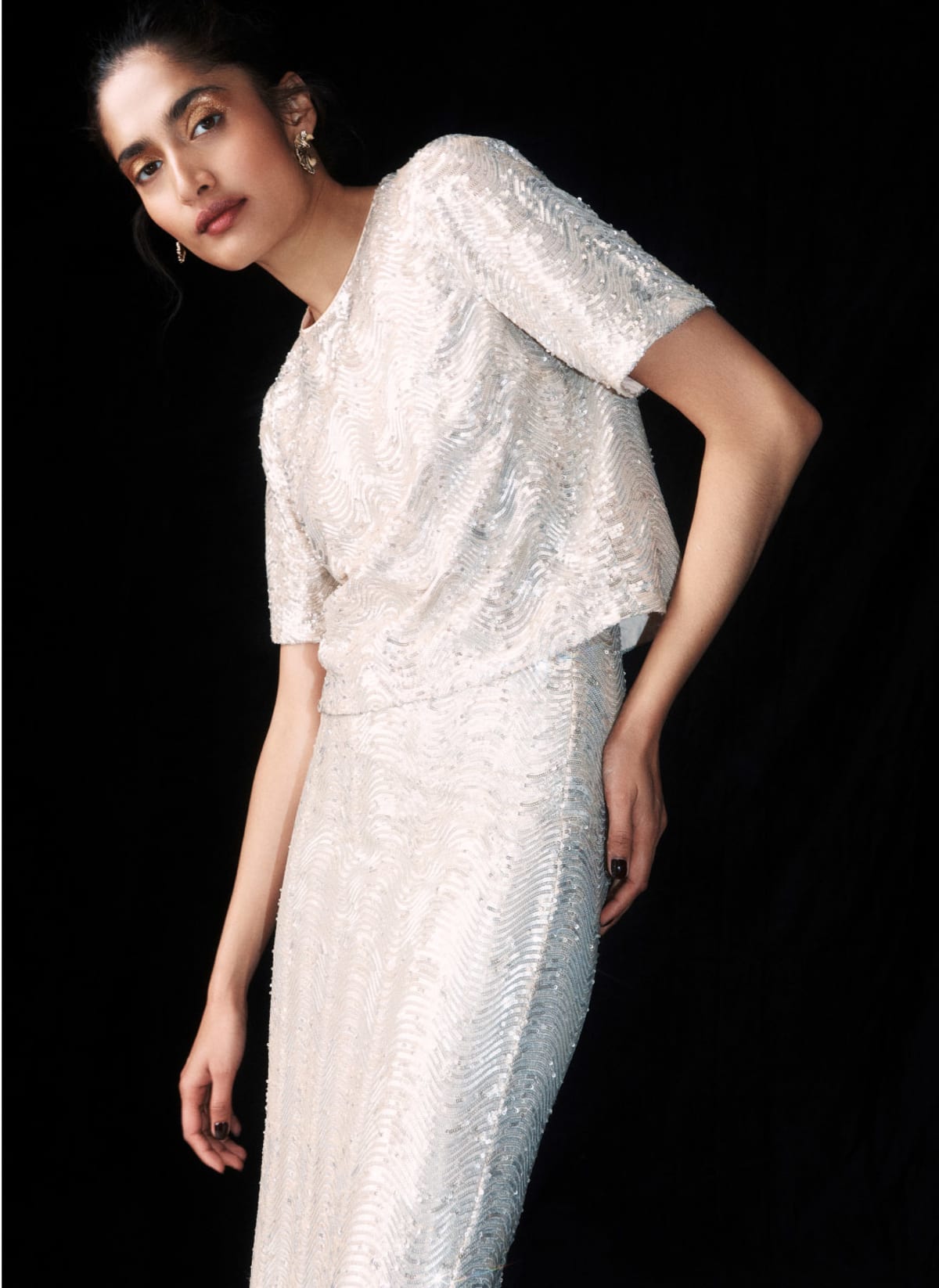 Model photographed in sequin top.