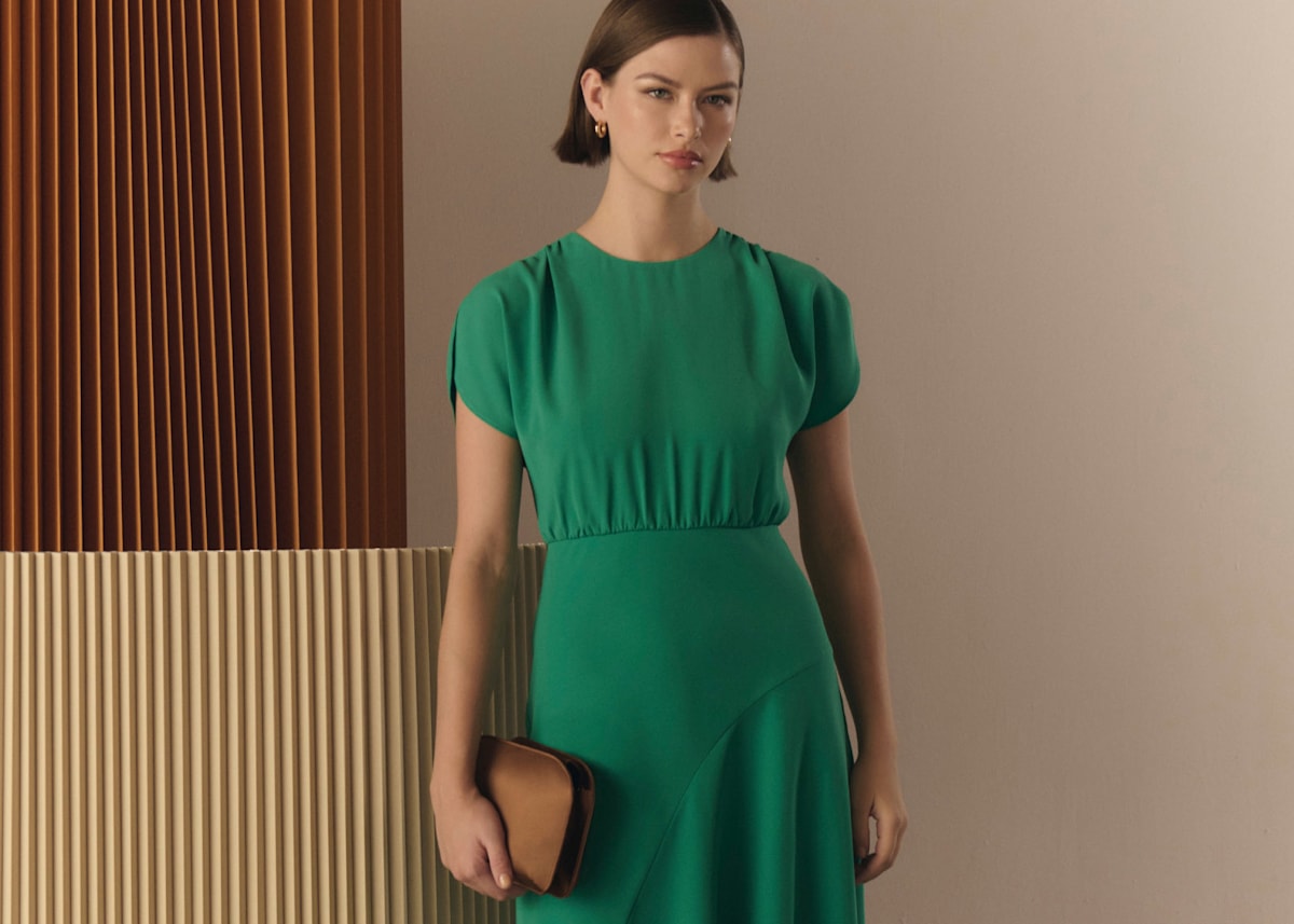 Model photographed in a green dress.
